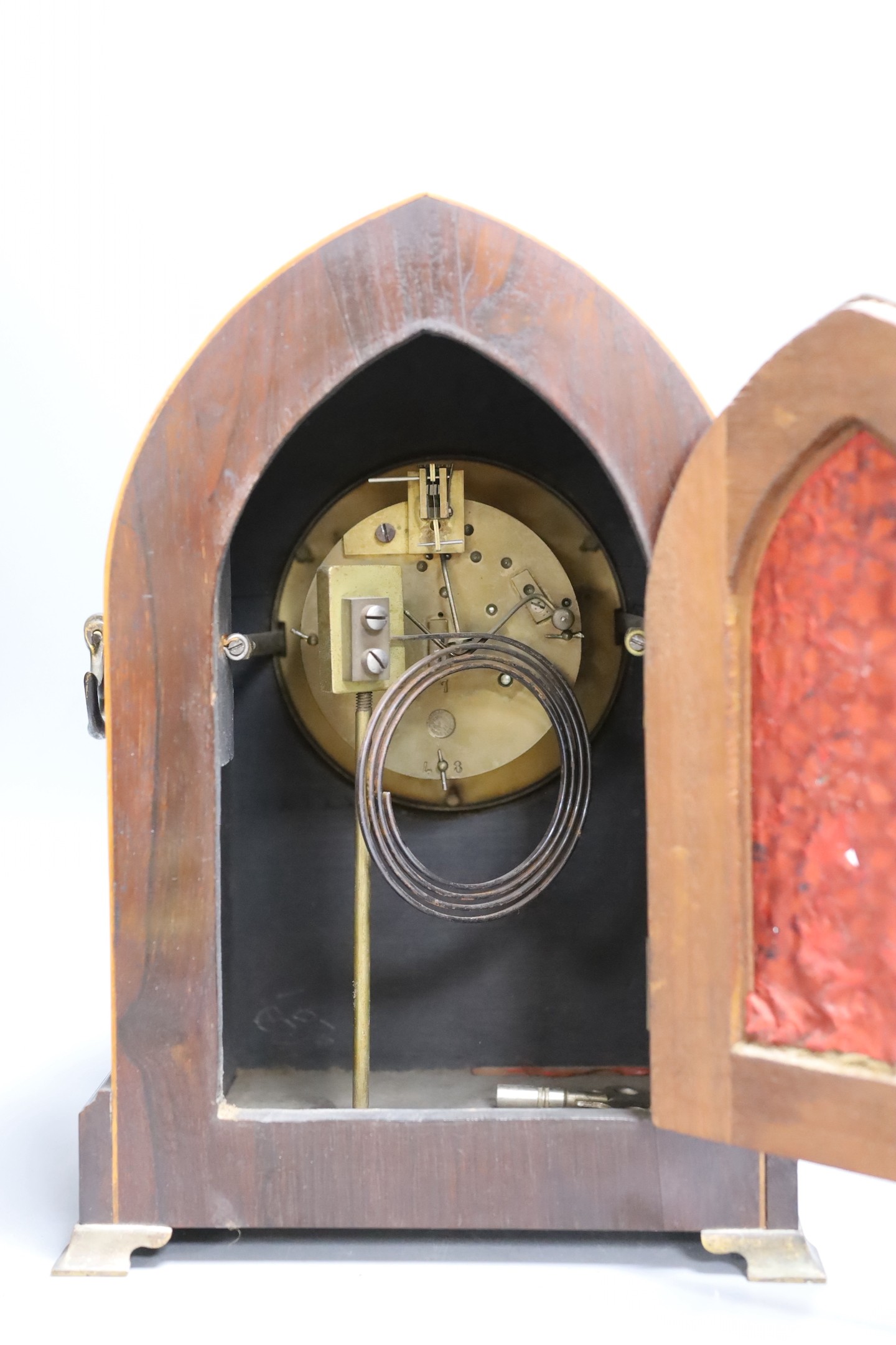 An early 20th century mahogany inlaid dome topped mantel clock, 30 cms high.